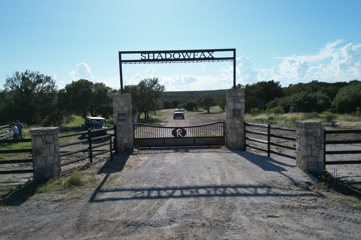 Stone-column ranch entrance and steel gate built by Elevation Development